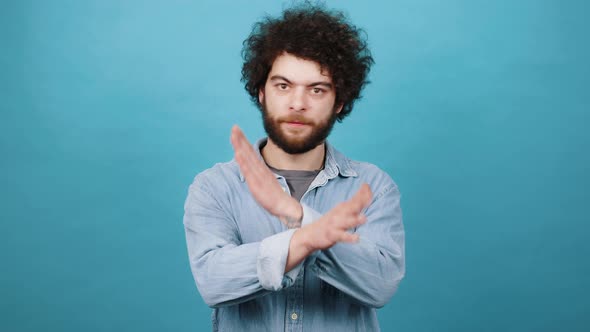 Bearded Man with Kinky Hair Shows Stop Gesture Saying No