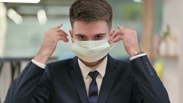 Cautious Young Businessman Wearing Protective Face Mask