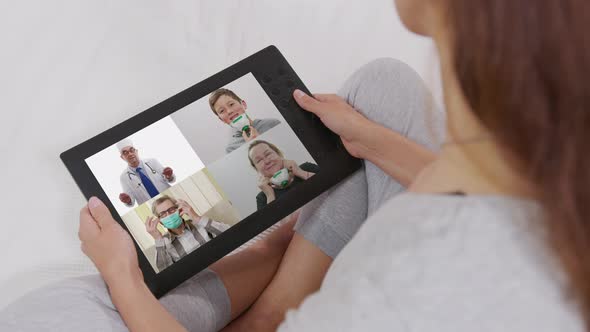 Woman Using Video Conferencing Technology for Video Call with Colleagues at Home and in Offices