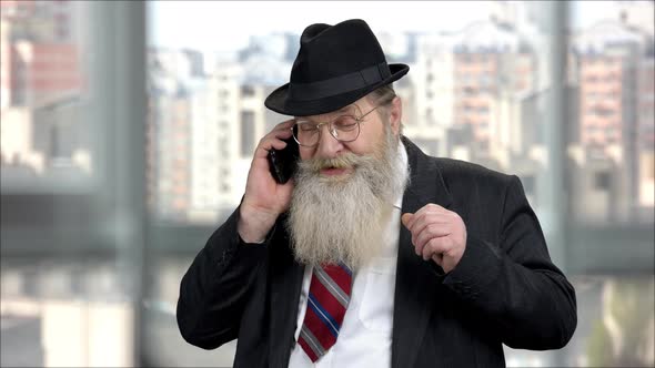Old Senior Longbearded Businessman Talking on Phone