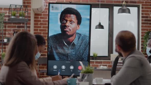 Diverse Workmates Talking to Man on Online Video Call Conference