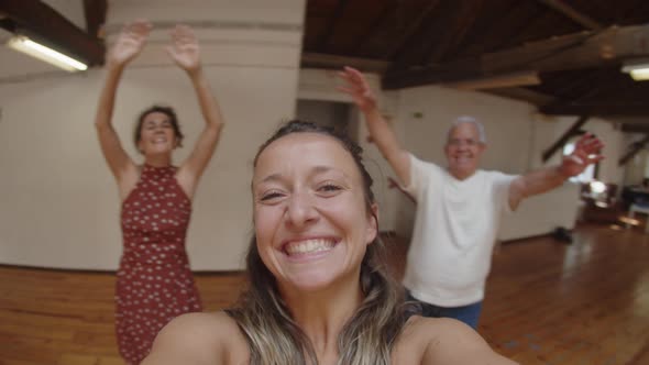 Dance Teacher Circling Around and Recording Video with Dancers