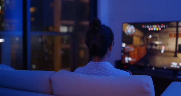 Woman play tv game at home in the evening