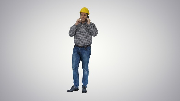 Construction worker using smartphone on gradient background.