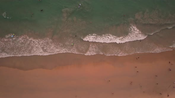 Surfers Catch a Wave at Sunset