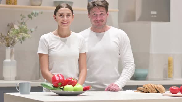 Mixed Race Couple Showing Yes Sign in Kitchen Head Shake