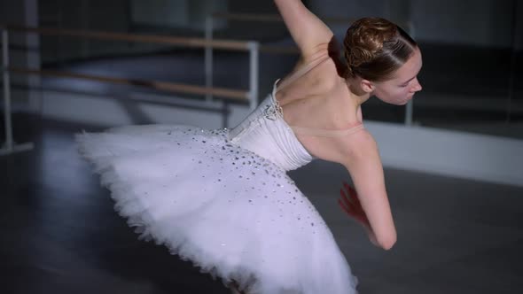 Medium Shot Slim Woman in Ballet Tutu Making Steps Rehearsing Movement Indoors