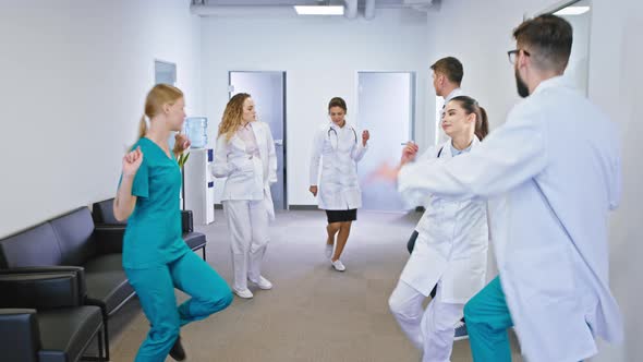 Charismatic Doctors and Nurses Dancing Excited 