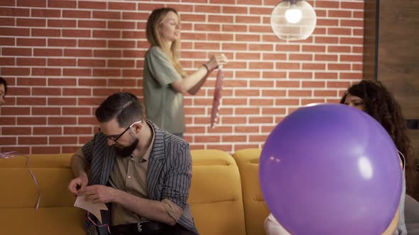 Positive Caucasian Men and Women Having Fun Preparing Partying Indoors