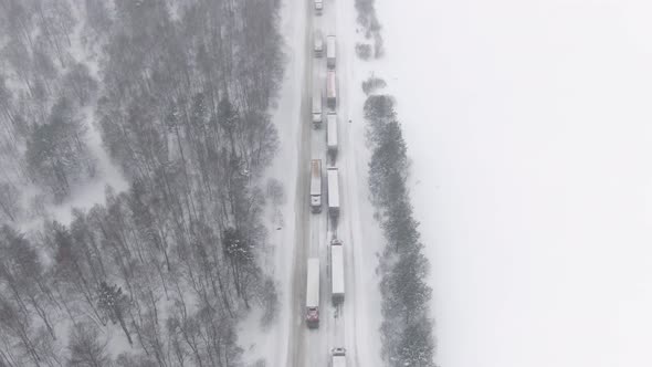 Trucks are Stuck in Traffic on a Snowcovered Highway