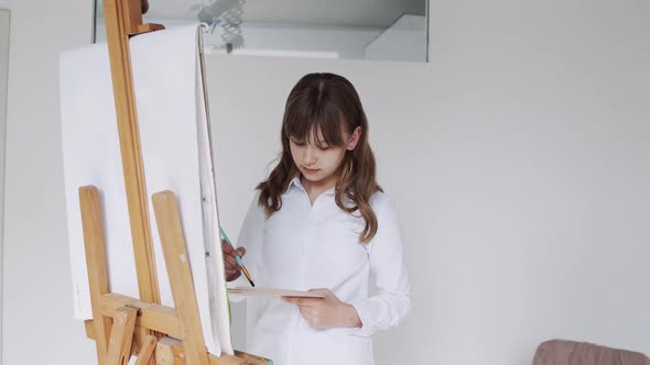 Child Painting on Easel School Kid in Workshop Class