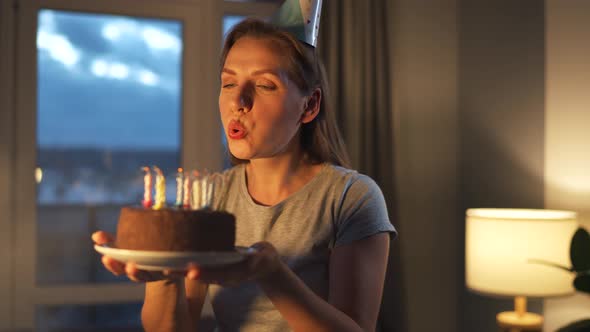 Happy Excited Woman Making Cherished Wish and Blowing Candles on Holiday Cake Celebrating Birthday