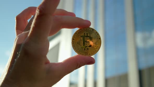 Hand with Bitcoin Crypto Coin