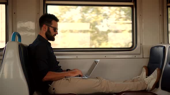 Mobile Worker Typing On Laptop In Train. Freelancer Internet Online Meeting Webinar. Distance Job.