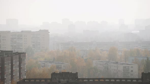 Aerial View of Roofs of Buildings in Urban Area in Fog on Autumn Day