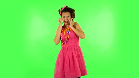 Girl Shocked and Fearfully Screams. Green Screen at Studio