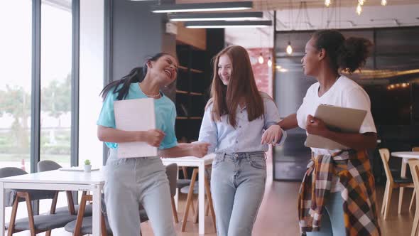 Multiethnic students having fun chatting in school talking and laughing together.