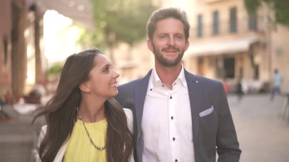 Young Couple Walking in Bright Sunshine