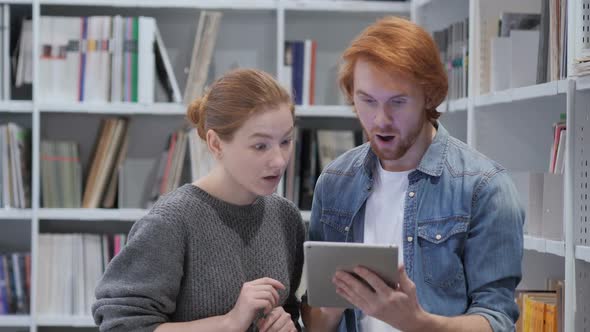 Wondering Team Using Tablet PC in Shock at Work