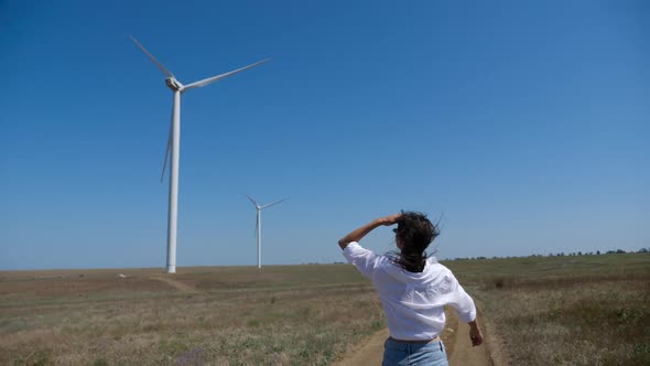 Young Woman in a Shirt and Denim Shorts Walks