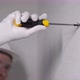 Builder Worker Makes Repairs in Apartment Screwing Screw in a Concrete Wall - VideoHive Item for Sale