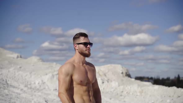 Muscular athletic bodybuilder man posing outdoor