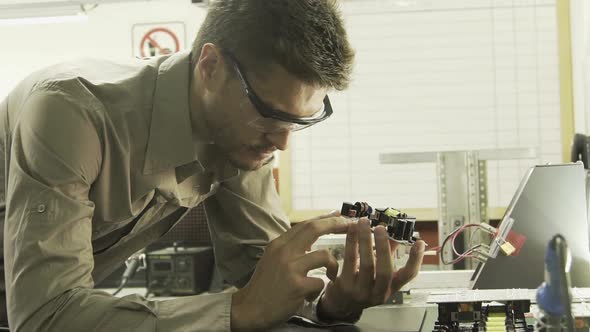 Electrical engineer scrutinizing circuit board