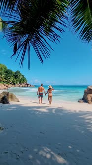 Men and Women on the Beach of Anse Cocos La Digue Seychelles Tropical Beach During Luxury Vacation