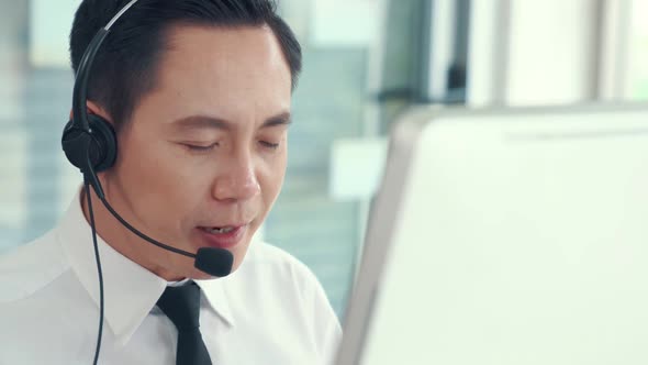 Businessman Wearing Headset Working Actively in Office