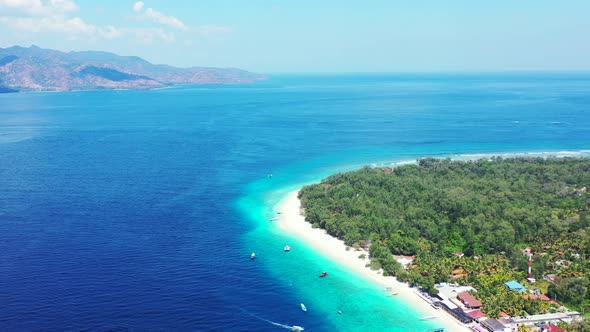 Daytime aerial travel shot of a summer white paradise sand beach and aqua blue ocean background