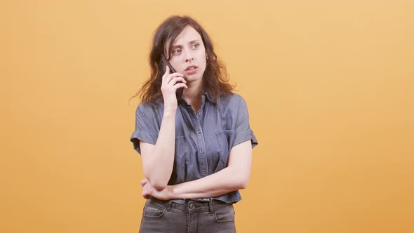 Young Woman Talks on Her Phone and Receives Great News