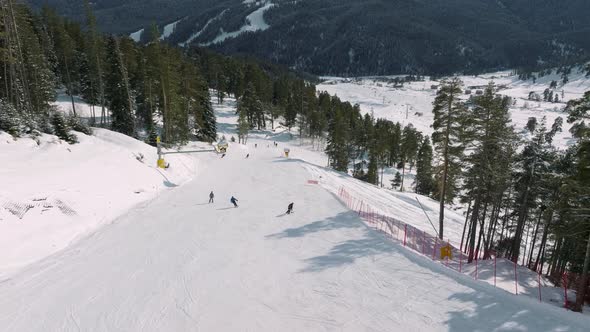 Aerial View of a Ski Resort with People Snowboarding and Skiing From a Hill