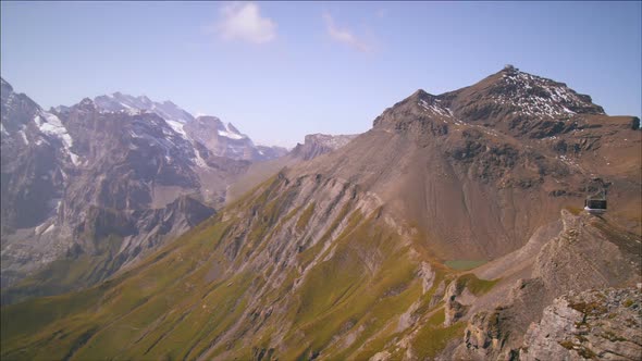 Panning shot of snow-covered mountaintops in Switzerland