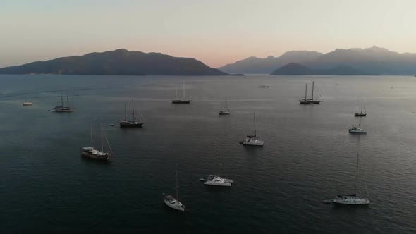 Aerial View Sea Yachts Standing at Parking on Background Hills and Sky Landscape. Ship Sailing in