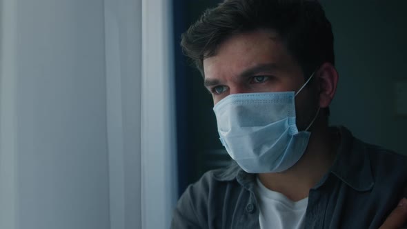 Brutal Sad Man Wearing Protective Medical Mask on Face