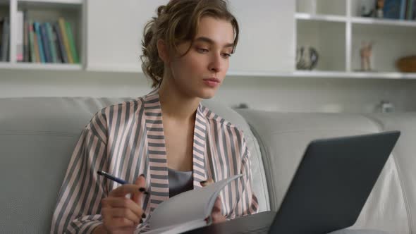 Beautiful Girl Making Notes Watching Online Webinar at Home Office Closeup