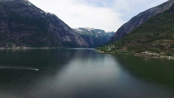 Small boat passing through Hardanger fjord in Norway.