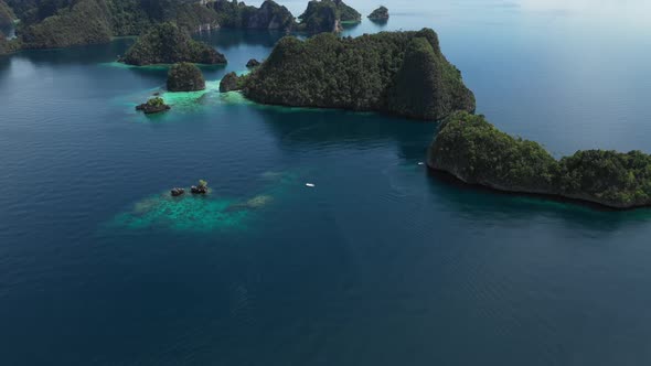 Areal shot over the beautiful lagoon of Misool in Indonesia. Blue water with turquoise spots where c
