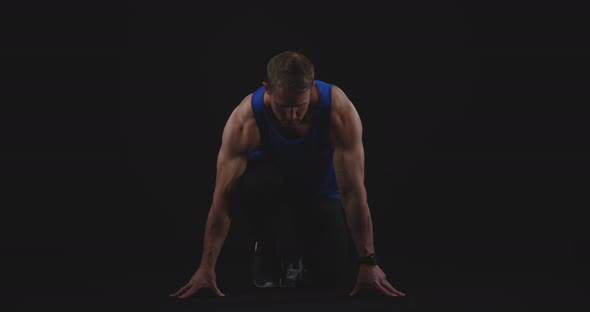 Male runner on starting blocks