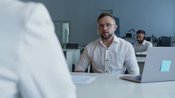 Bearded Man in Black Glasses Talks with His Partner