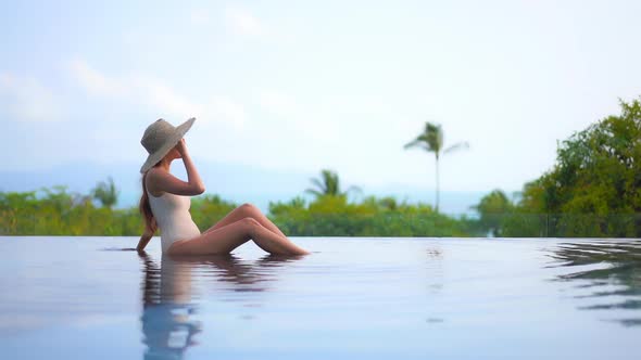 Young asian woman enjoy around outdoor swimming pool for leisure