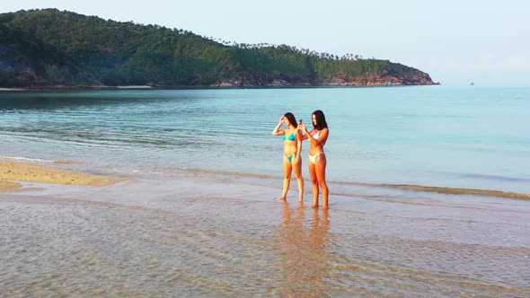 Women tan on marine tourist beach holiday by turquoise sea with white sand background of Thailand ne