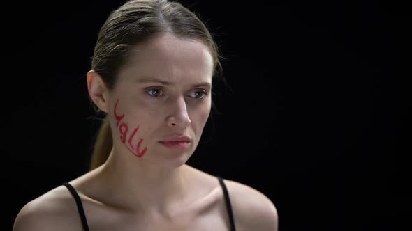 Frightened Woman Putting Up With Ugly Inscription on Her Cheek, Humiliation