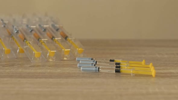 Nurse's Hands Preparing a Syringe for Injection or Vaccination