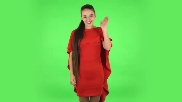 Pretty Young Woman Is Waving Hand and Showing Gesture Come Here. Green Screen