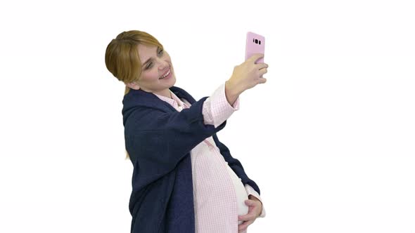 Happy Young Pregnant Woman Taking Selfie on White Background
