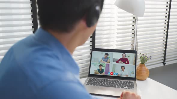 Asian businessman use laptop computer video call for meeting and brainstorm with office colleagues.