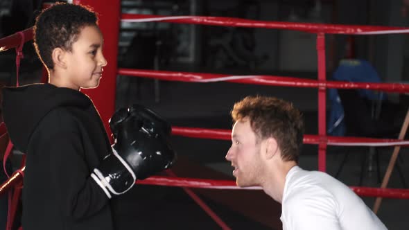 Boy Boxer Practicing Punches with His Coach at Gym