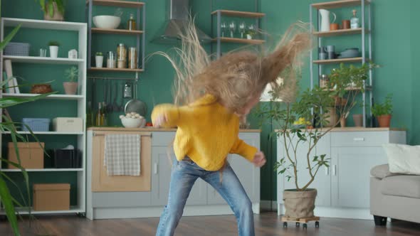 Active Cheerful Teenage Girl Dancing Vigorously Fooling Around with Her Hair