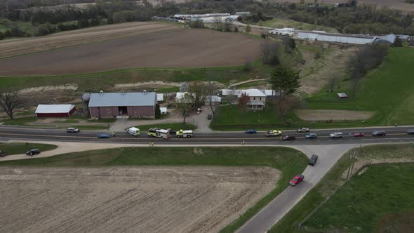 aerial view of accident scene on rural highway in front of a farm in autumn. Cultivated fields.
